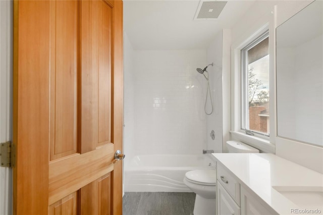 full bathroom featuring visible vents, toilet, wood finished floors,  shower combination, and vanity