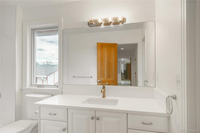 bathroom featuring vanity, toilet, and walk in shower