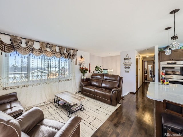 living area with baseboards and wood finished floors