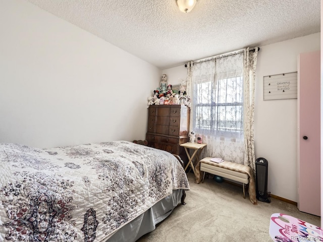 bedroom with a textured ceiling, baseboards, and carpet flooring