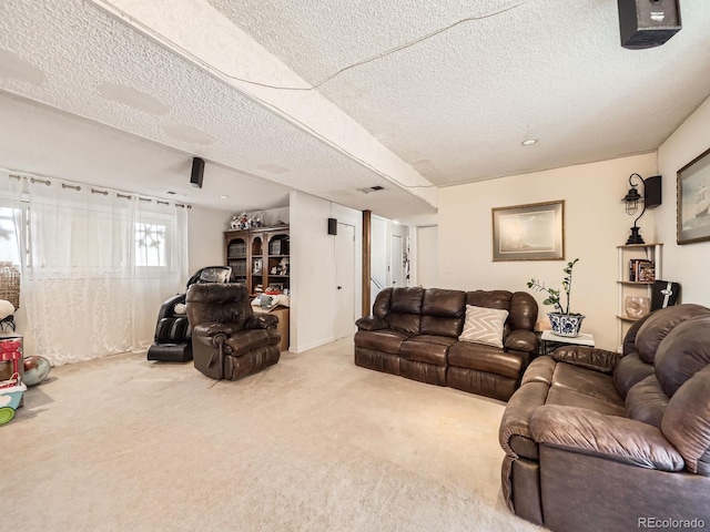 living area with a textured ceiling, carpet flooring, and visible vents