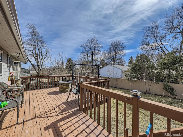 wooden terrace featuring a fenced backyard