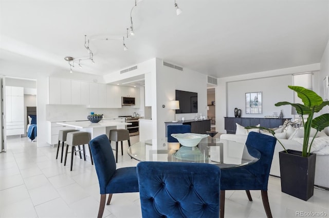 dining area with light tile patterned flooring and visible vents