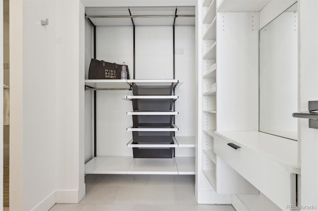 walk in closet with tile patterned floors