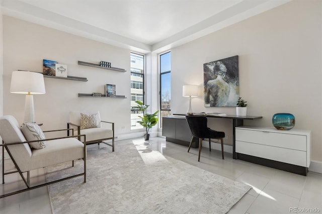 sitting room featuring tile patterned flooring and baseboards