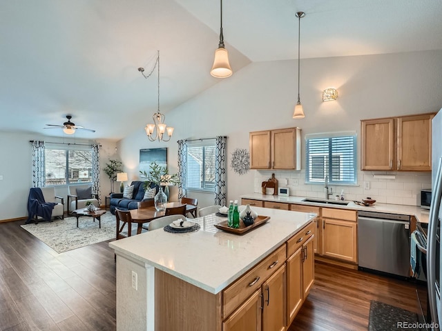 kitchen featuring dishwasher, light countertops, a sink, and dark wood finished floors