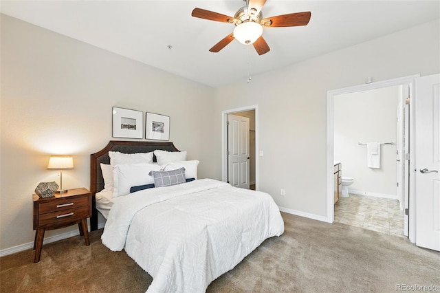 carpeted bedroom with connected bathroom, baseboards, and ceiling fan