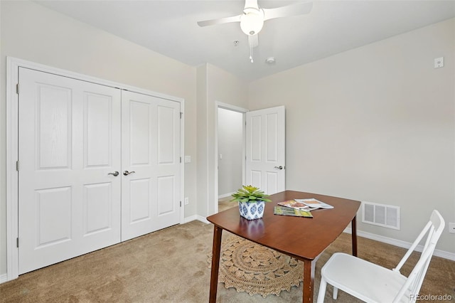 office with baseboards, visible vents, and light colored carpet