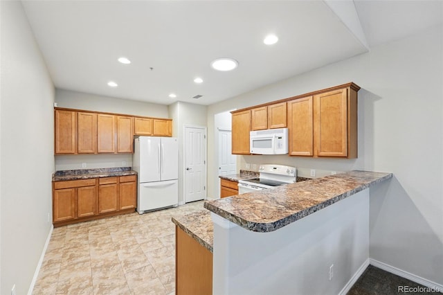 kitchen featuring brown cabinetry, a peninsula, white appliances, baseboards, and recessed lighting