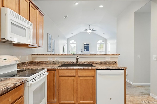 kitchen featuring a sink, ceiling fan, brown cabinetry, and white appliances