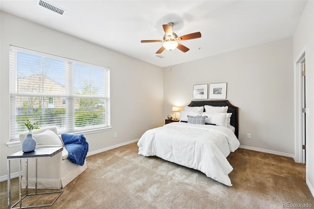bedroom featuring visible vents, a ceiling fan, baseboards, and carpet floors
