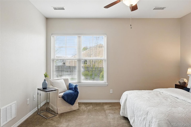 carpeted bedroom with visible vents and multiple windows