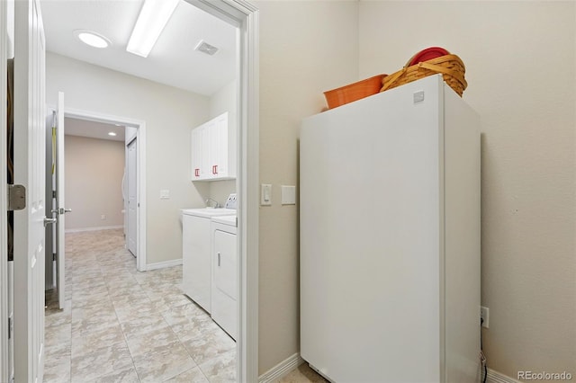 washroom featuring cabinet space, visible vents, and washer and dryer