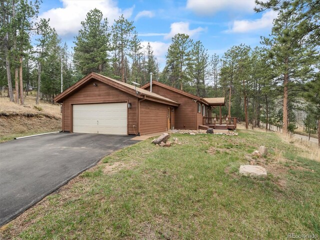 14 Aspen Dr, Bailey, CO 80421 - view of home's exterior with an attached garage, a lawn, asphalt driveway, and a wooden deck