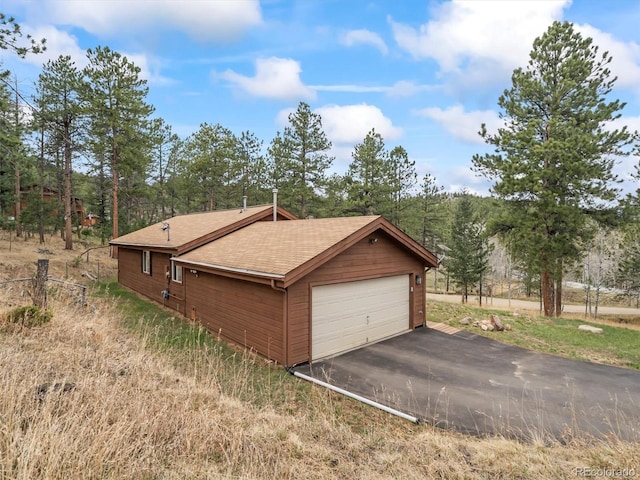 14 Aspen Dr, Bailey, CO 80421 - view of side of property featuring a shingled roof and a garage