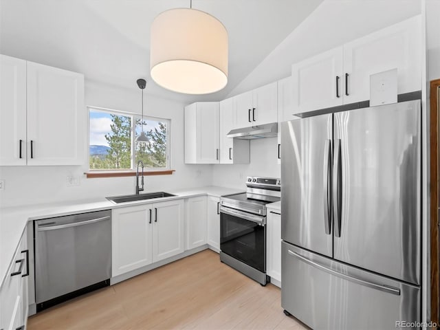 14 Aspen Dr, Bailey, CO 80421 - kitchen with stainless steel appliances, a sink, under cabinet range hood, white cabinets, and lofted ceiling