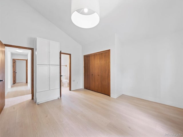 14 Aspen Dr, Bailey, CO 80421 - unfurnished bedroom with light wood-type flooring, high vaulted ceiling, a closet, and ensuite bath