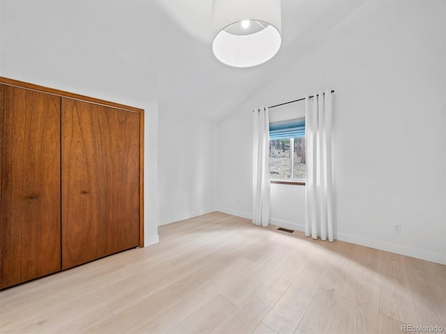 14 Aspen Dr, Bailey, CO 80421 - unfurnished bedroom with lofted ceiling, light wood-type flooring, baseboards, and a closet