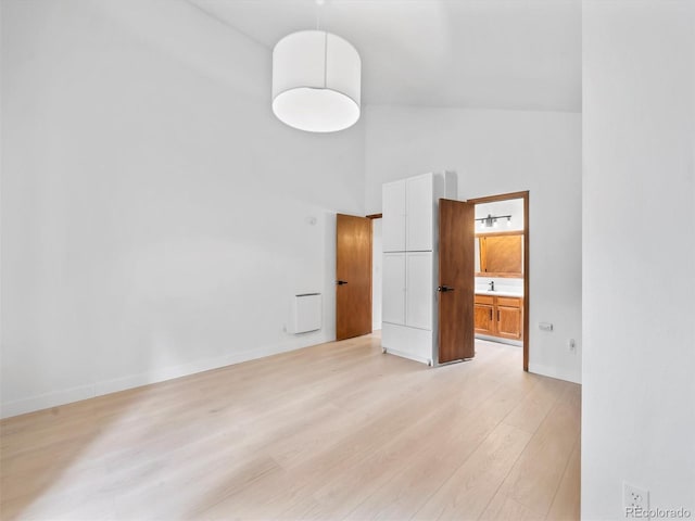 14 Aspen Dr, Bailey, CO 80421 - unfurnished bedroom with high vaulted ceiling, light wood-type flooring, baseboards, and ensuite bath