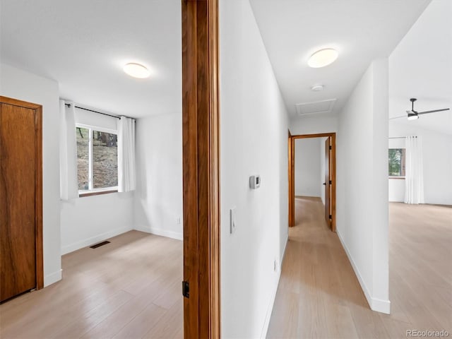 14 Aspen Dr, Bailey, CO 80421 - hall featuring light wood-type flooring, baseboards, and attic access