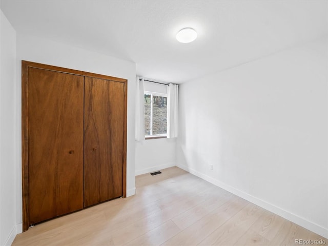 14 Aspen Dr, Bailey, CO 80421 - unfurnished bedroom featuring light wood-style floors, a closet, and baseboards