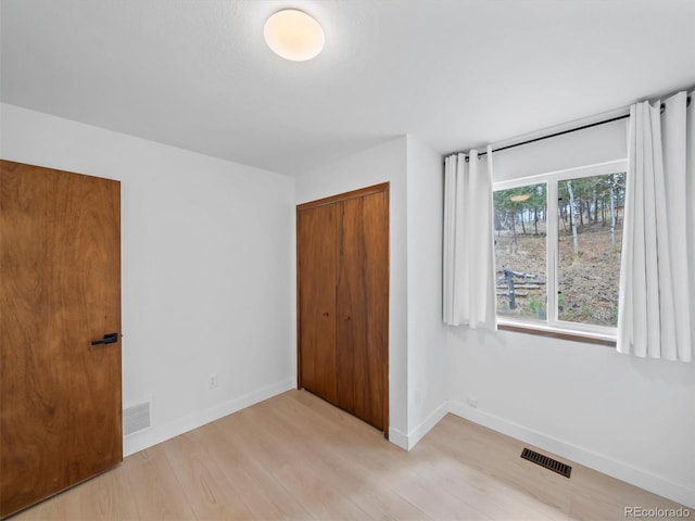 14 Aspen Dr, Bailey, CO 80421 - unfurnished bedroom featuring light wood-style flooring, a closet, and baseboards