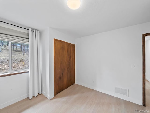 14 Aspen Dr, Bailey, CO 80421 - unfurnished bedroom with light wood finished floors, a closet, and baseboards