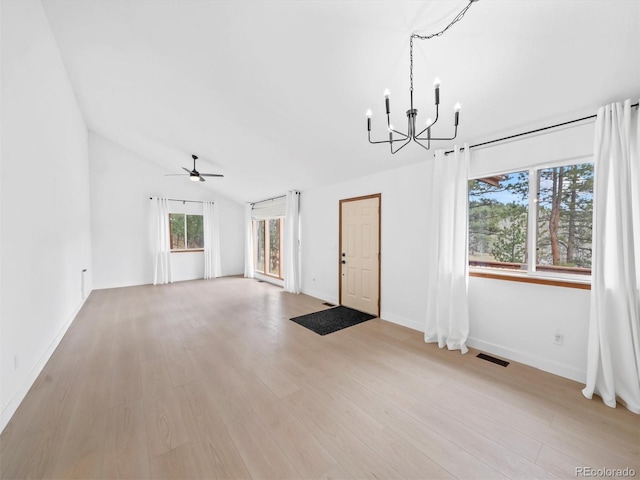 14 Aspen Dr, Bailey, CO 80421 - unfurnished living room featuring a chandelier, a ceiling fan, light wood-type flooring, baseboards, and lofted ceiling