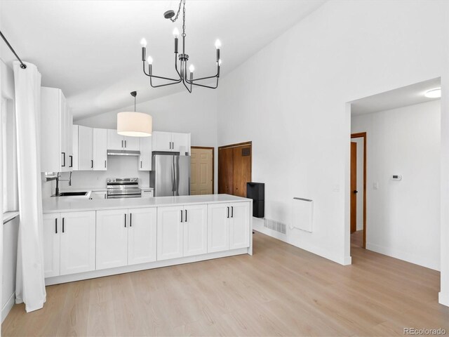 14 Aspen Dr, Bailey, CO 80421 - kitchen featuring stainless steel appliances, a sink, light wood-style flooring, a chandelier, and white cabinets