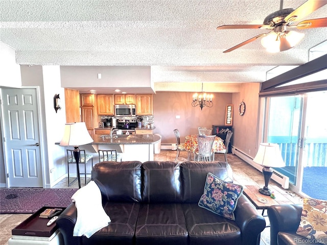 512 Tenderfoot St Unit 143, Dillon, CO 80435 - living room with a chandelier, baseboards, ceiling fan, and a textured ceiling
