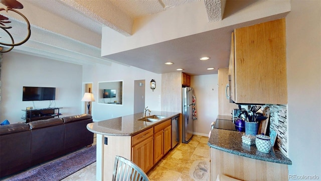 512 Tenderfoot St Unit 143, Dillon, CO 80435 - kitchen featuring stainless steel appliances, open floor plan, dark stone counters, recessed lighting, and brown cabinets
