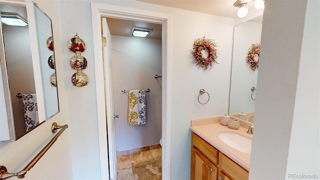 512 Tenderfoot St Unit 143, Dillon, CO 80435 - bathroom featuring vanity, stone finish floors, and toilet