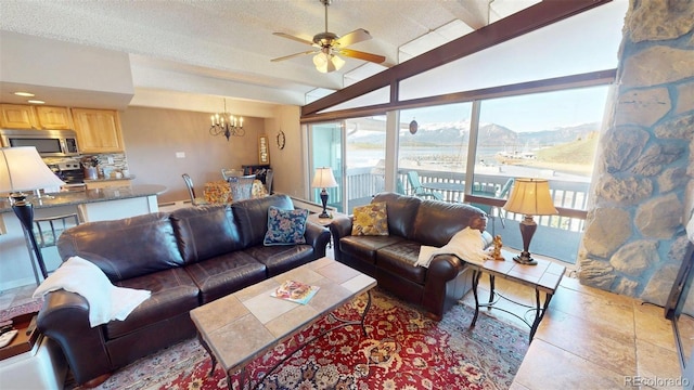 512 Tenderfoot St Unit 143, Dillon, CO 80435 - living room featuring a chandelier, a ceiling fan, lofted ceiling, tile patterned flooring, and a textured ceiling