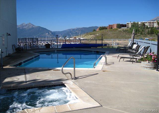 512 Tenderfoot St Unit 143, Dillon, CO 80435 - community pool with a mountain view, a patio area, and a community hot tub