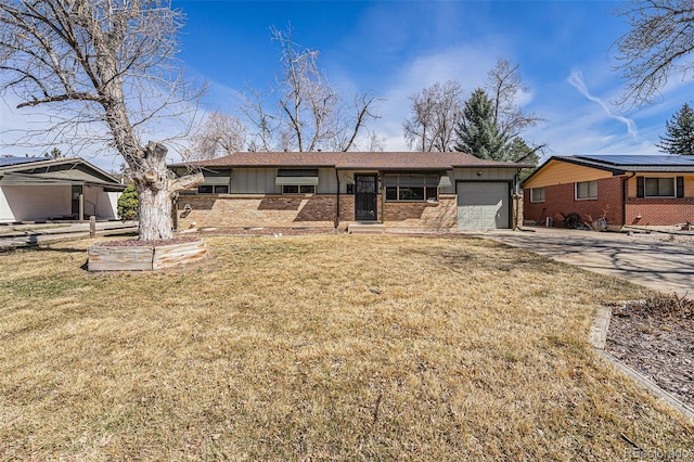 single story home with a garage, a front yard, brick siding, and driveway