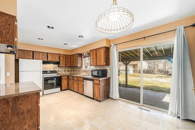 kitchen featuring a sink, electric range oven, black microwave, extractor fan, and dishwasher