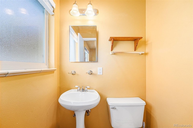 half bath with toilet and a sink