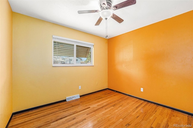 unfurnished room featuring visible vents, baseboards, a ceiling fan, and light wood finished floors