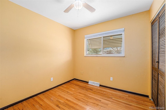 unfurnished bedroom featuring visible vents, a ceiling fan, a closet, light wood finished floors, and baseboards