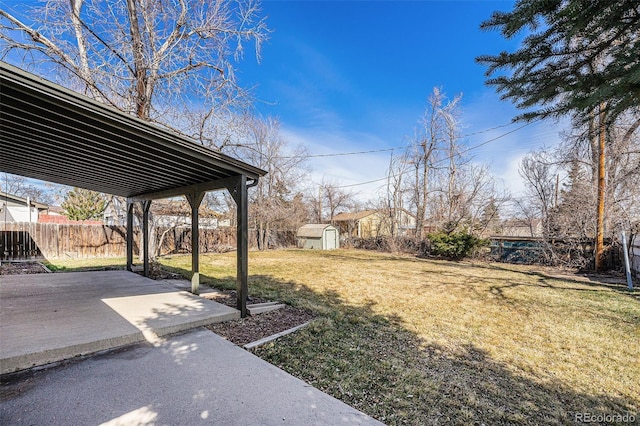 view of yard featuring a fenced backyard, a patio, a storage shed, and an outdoor structure