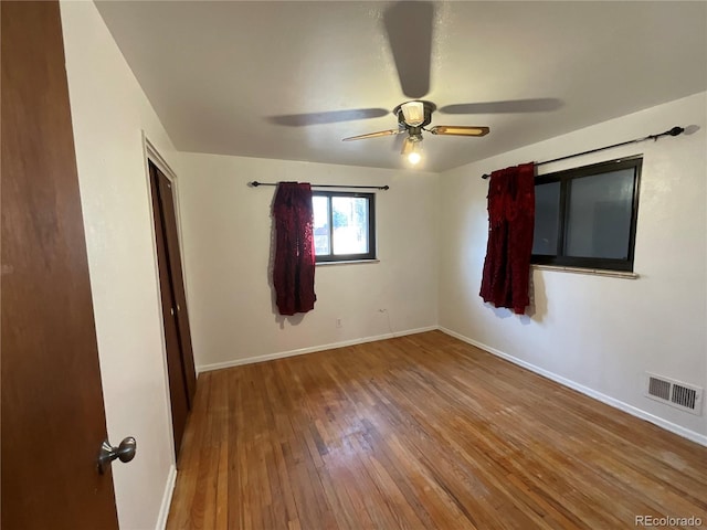 spare room with wood-type flooring and ceiling fan