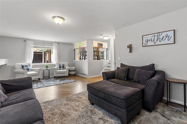 19935 E Stanford Dr, Centennial, CO 80015 - living area featuring wood finished floors, stairway, and baseboards