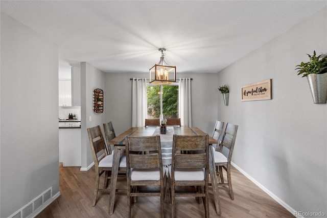 19935 E Stanford Dr, Centennial, CO 80015 - dining room featuring light wood-type flooring, a chandelier, and baseboards