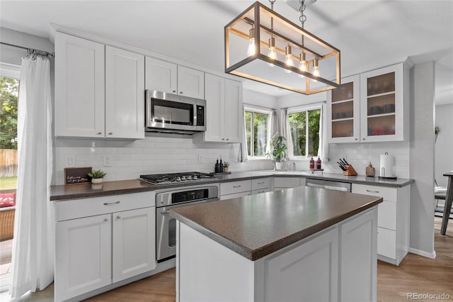 19935 E Stanford Dr, Centennial, CO 80015 - kitchen with stainless steel appliances, dark countertops, decorative backsplash, and healthy amount of natural light