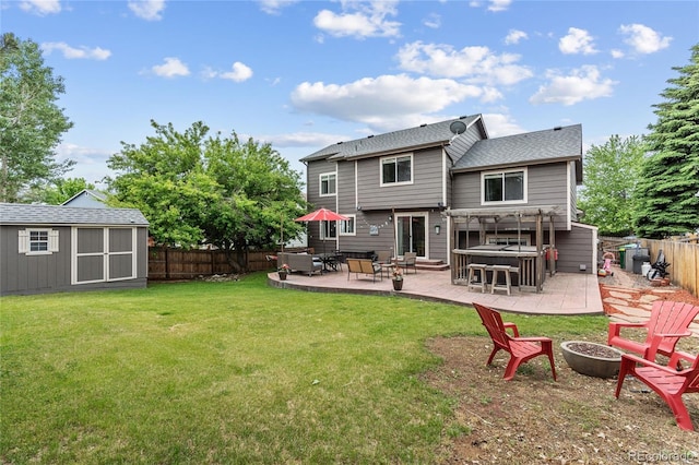 19935 E Stanford Dr, Centennial, CO 80015 - back of property featuring an outdoor fire pit, a hot tub, a patio, and a shingled roof