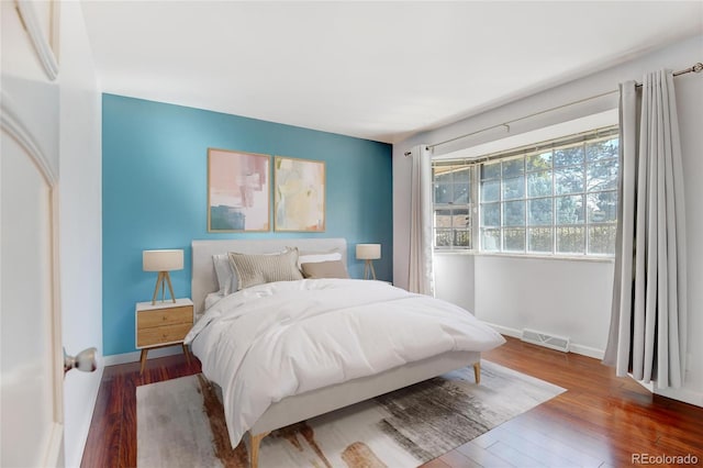 bedroom with hardwood / wood-style floors