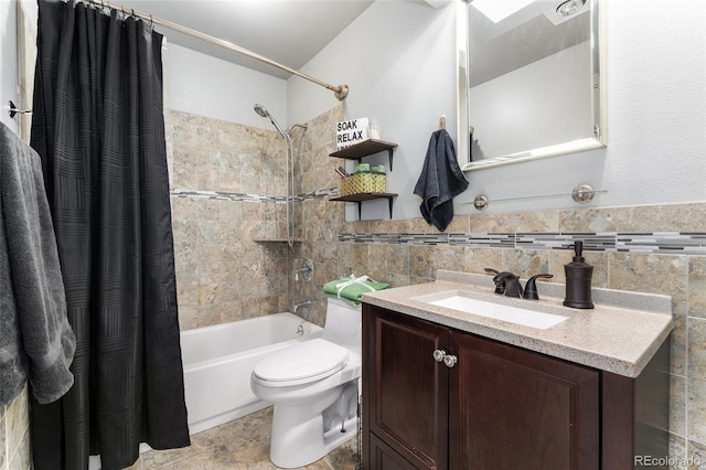 full bathroom featuring shower / tub combo with curtain, vanity, tile walls, and toilet