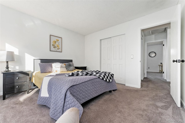 carpeted bedroom featuring a textured ceiling and a closet