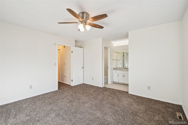 unfurnished bedroom with connected bathroom, carpet floors, ceiling fan, and sink