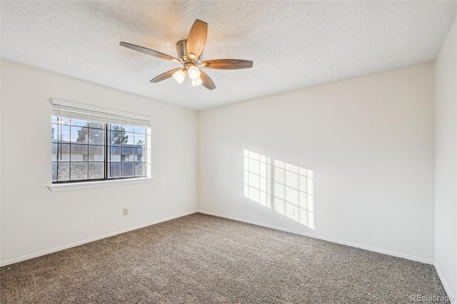 carpeted empty room featuring a textured ceiling and ceiling fan